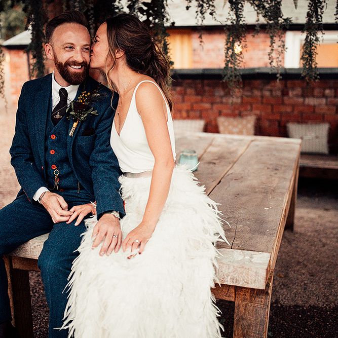 Bride in a Charlie Brear Payton Bridal Gown &amp; Piora Feather Skirt and Groom in a Navy Suit