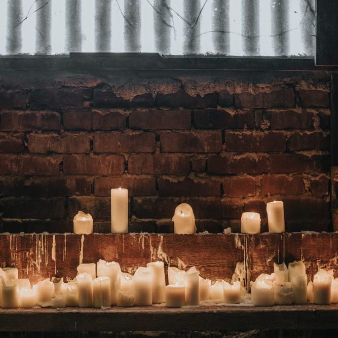 Pillar candles for cosy winter barn ceremony