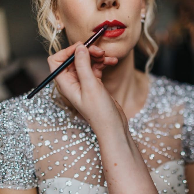 Red lip with brides embellished wedding dress for New Years eve party wedding
