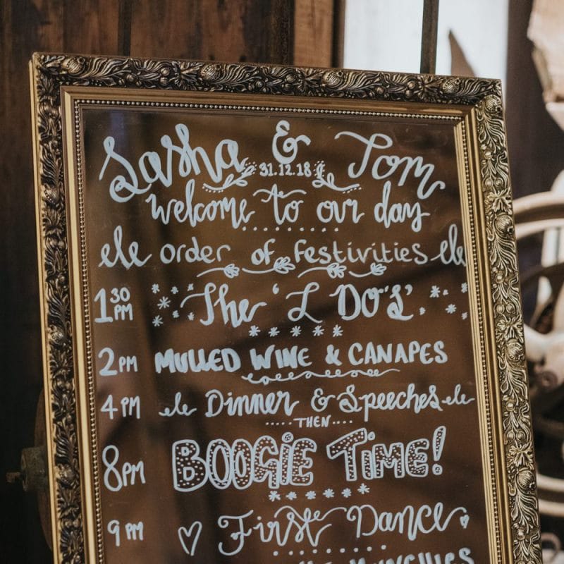 Mirror wedding sign with white writing for winter celebration with opulent colours and sparkle