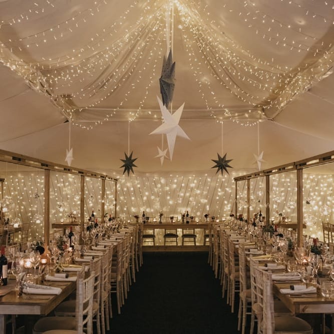 Marquee winter reception styling with star decor and fairy lights for New Years eve celebration