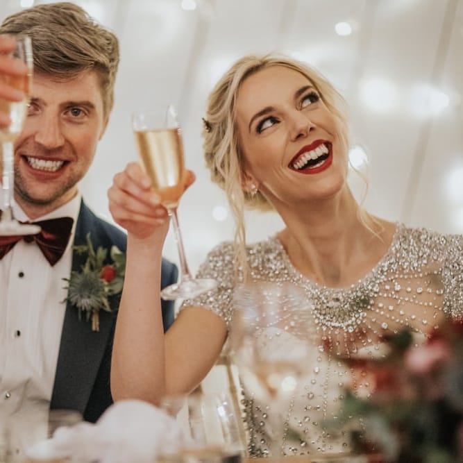 Bride wearing an embellished wedding dress and classic red lip for winter wedding reception