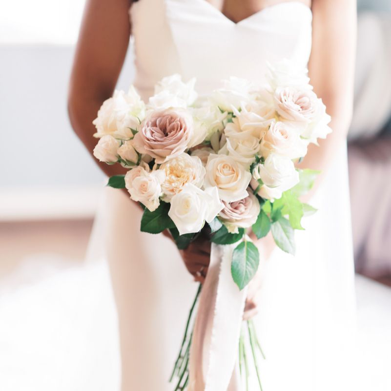 Classic white and pink rose bouquet tied with ribbon