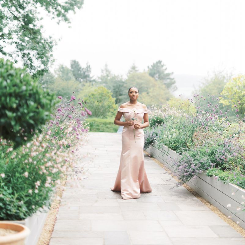 Bridesmaids in pink homemade odd the shoulder dress walking down the aisle
