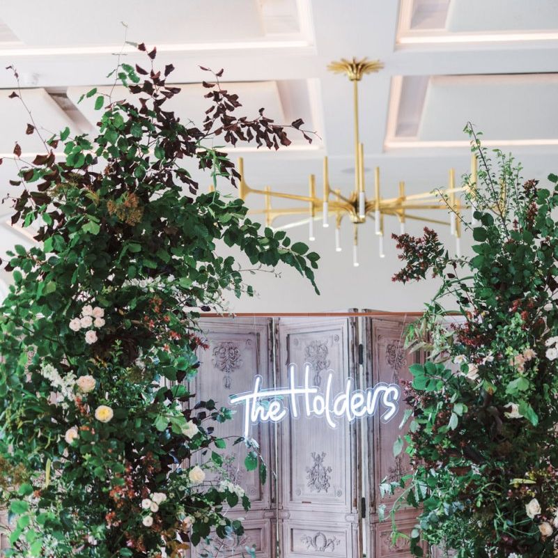 Personalised neon sign wedding decor and floral arrangements