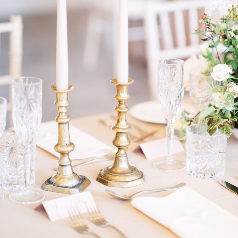Gold candlesticks and taper candles for classic wedding at Deer Park Country House, Devon