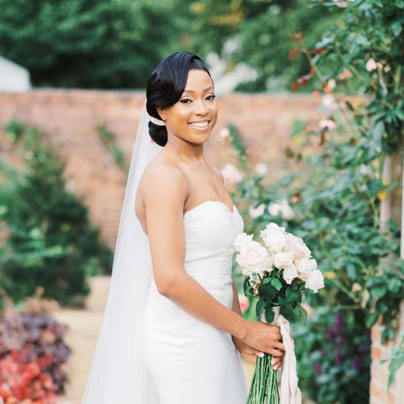 Beautiful bride in off the shoulder Enzoani wedding dress and veil