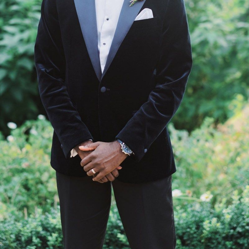 Groom in black tuxedo with velvet dinner jacket and bow tie