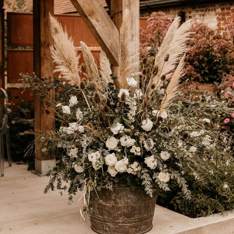 Pampas grass, foliage and white flower floral arrangement