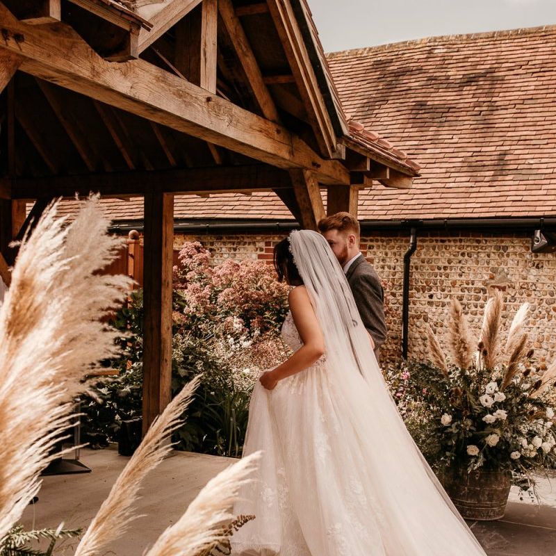 Bride wedding ceremony entrance in Enzoani wedding dress and cathedral length veil