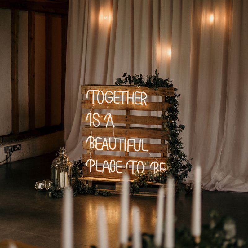 Together is a beautiful place to be neon wedding sign on wooden palette
