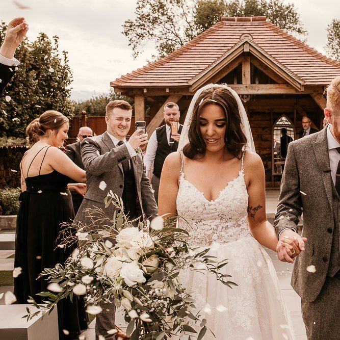 Wedding ceremony confetti exit at Southend Barns with bride in Enzoani wedding dress