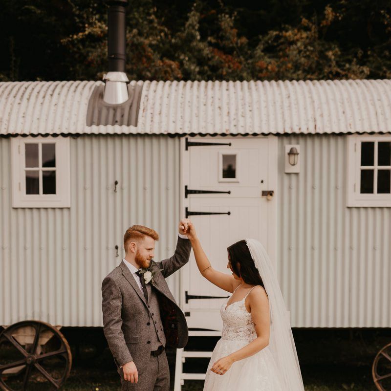 Bride in Enzoani wedding dress and groom in wool suit