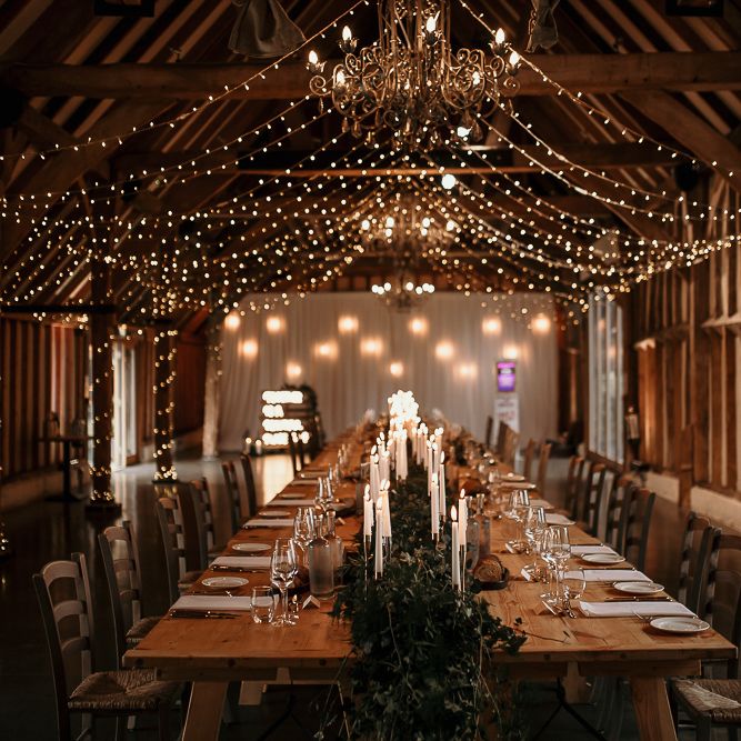Small wedding reception at Southend Barns with romantic candlelight  and fairy light canopy