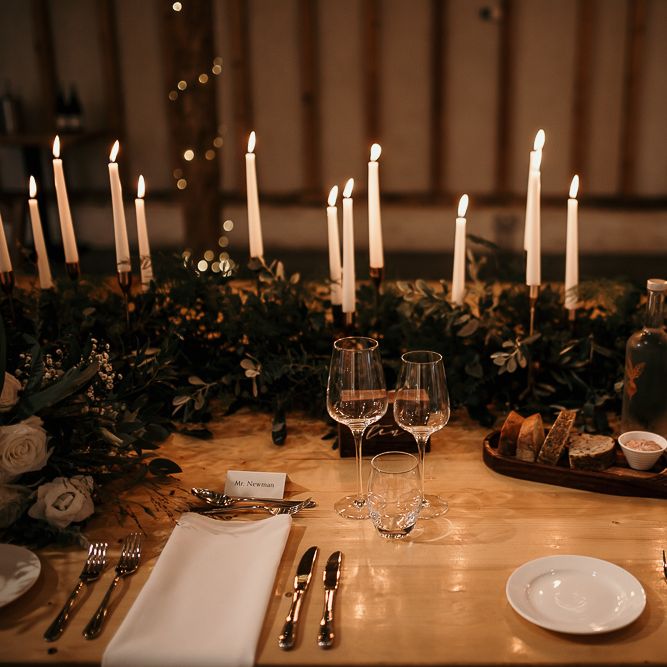 Foliage table runner and taper candles for centrepieces