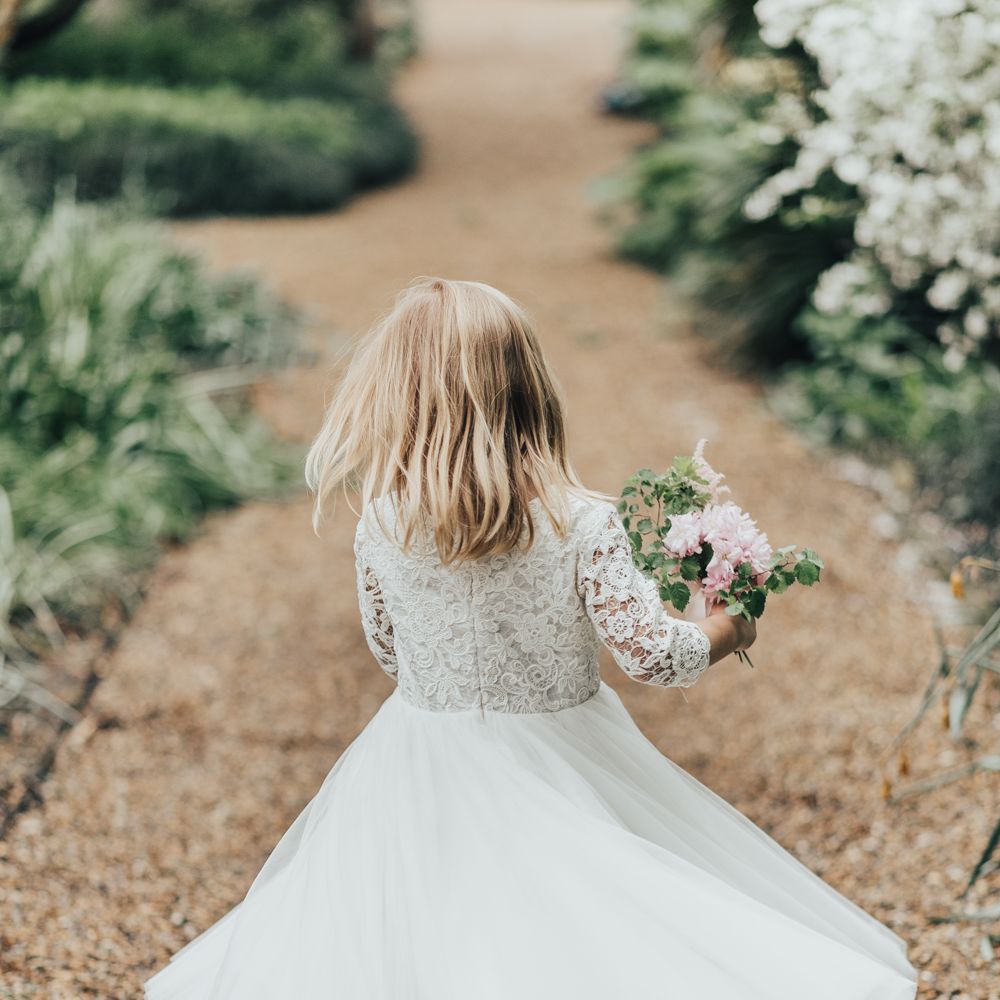 Flower Girl In White Dress // Disney Princess Bride Sleeping Beauty Inspired Wedding With Opulent Florals And Bride In Blush Pink With Images From Rebecca Carpenter Photography