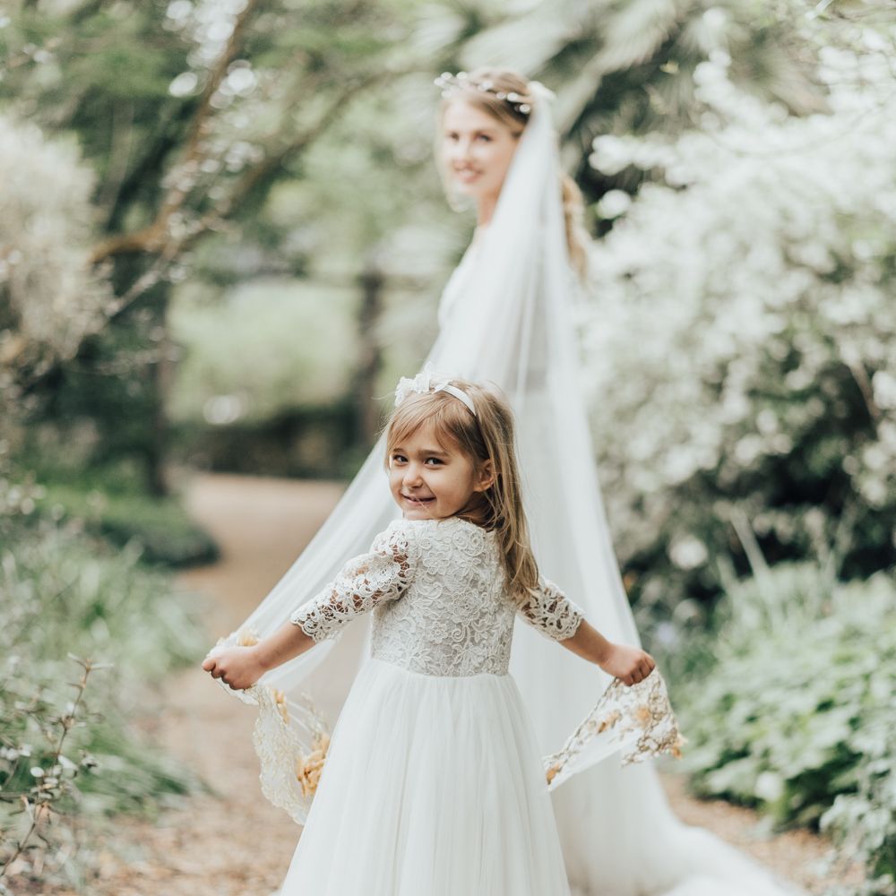 Flower Girl In White Dress // Disney Princess Bride Sleeping Beauty Inspired Wedding With Opulent Florals And Bride In Blush Pink With Images From Rebecca Carpenter Photography