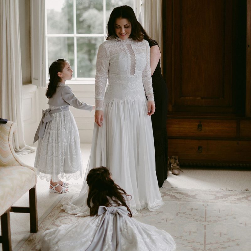 Bride in Homemade Wedding Dress with Lace Long Sleeves and High Neck Getting Ready