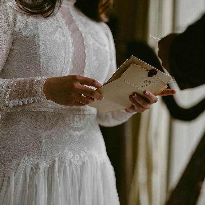 Bride in Homemade Wedding Dress with Lace Bodice and Long Sleeves Saying Her Vows