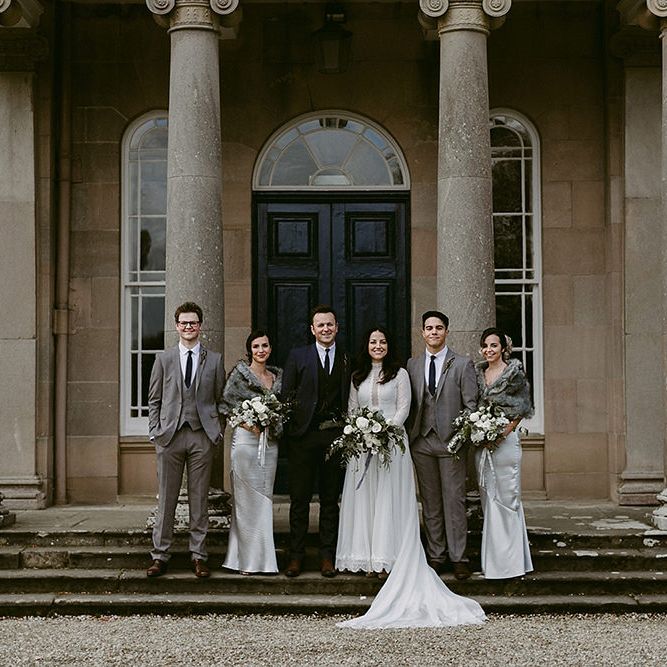 WeddingParty with Bridesmaids in Grey Satin Dresses &amp; Fur Stoles, Bride in a Homemade Wedding Dress with Lace Bodice and Long Sleeves, and Groomsmen in Grey Suits