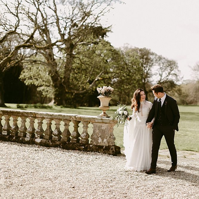 Bride in Homemade Wedding Dress with Long Sleeves and Groom in Zara Suit