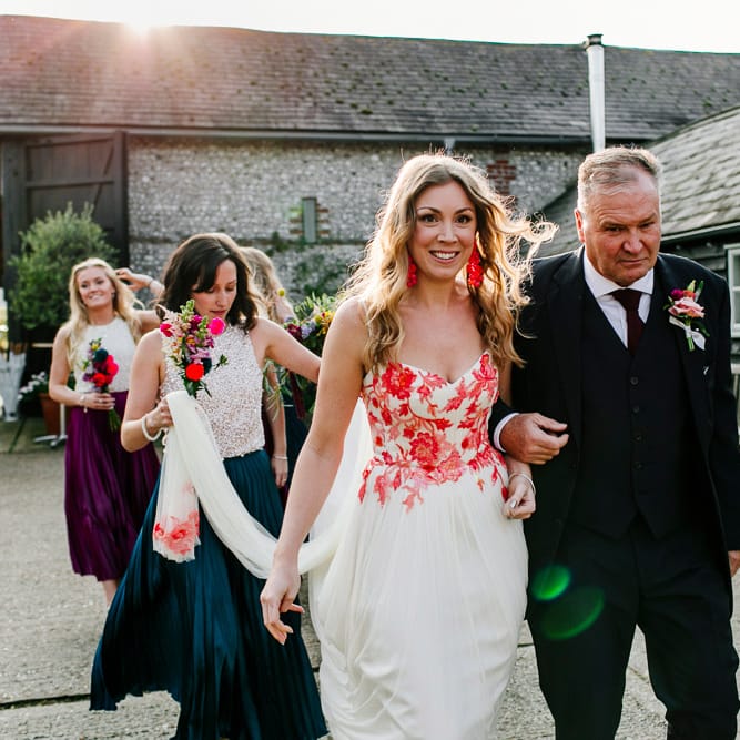 Bridal Entrance in Red &amp; White Joanne Fleming Design Wedding Dress | Colourful Alternative Winter Wedding at Upwaltham Barns, Sussex | Epic Love Story Photography