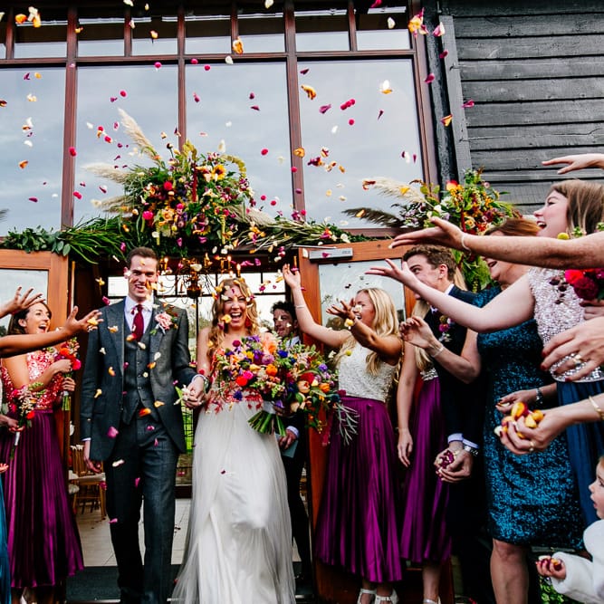 Confetti Moment |  Bride in Red &amp; White Joanne Fleming Design Wedding Dress | Groom in Suit Supply | Colourful Alternative Winter Wedding at Upwaltham Barns, Sussex | Epic Love Story Photography