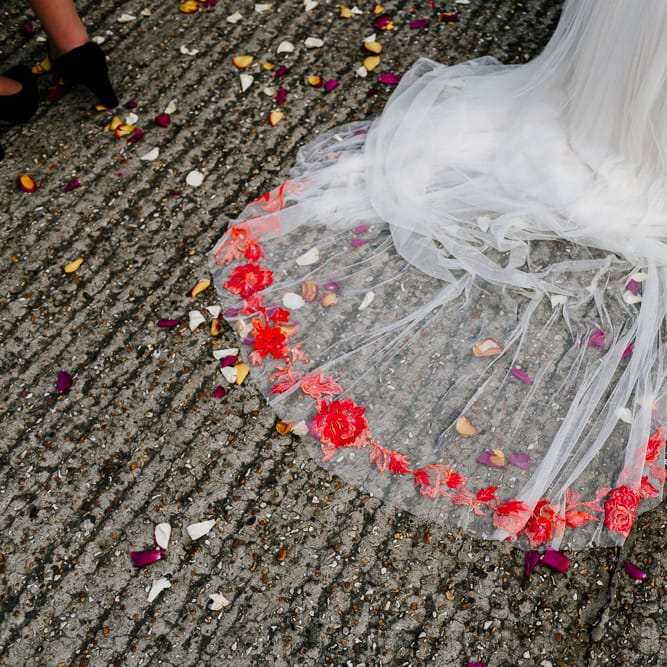 Confetti Moment |  Bride in Red &amp; White Joanne Fleming Design Wedding Dress | Colourful Alternative Winter Wedding at Upwaltham Barns, Sussex | Epic Love Story Photography