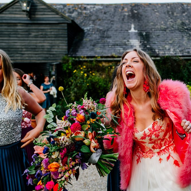 Bride in Red &amp; White Joanne Fleming Design Wedding Dress | Pink Faux Fur Jacket | Bridesmaids in Jewel Coloured Skirts &amp; Sequin Top Separates | Colourful Alternative Winter Wedding at Upwaltham Barns, Sussex | Epic Love Story Photography