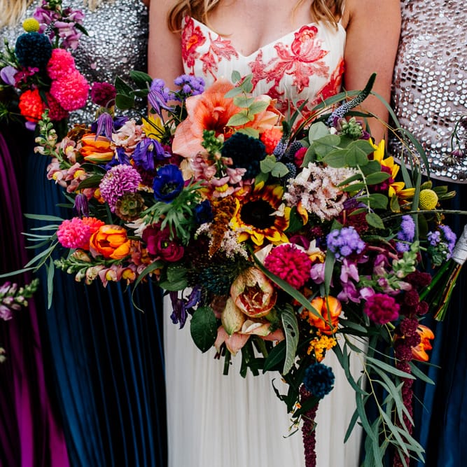 Oversized Bridal Bouquets | Bride in Red &amp; White Joanne Fleming Design Wedding Dress | Bridesmaids in Jewel Coloured Skirts &amp; Sequin Top Separates | Colourful Alternative Winter Wedding at Upwaltham Barns, Sussex | Epic Love Story Photography