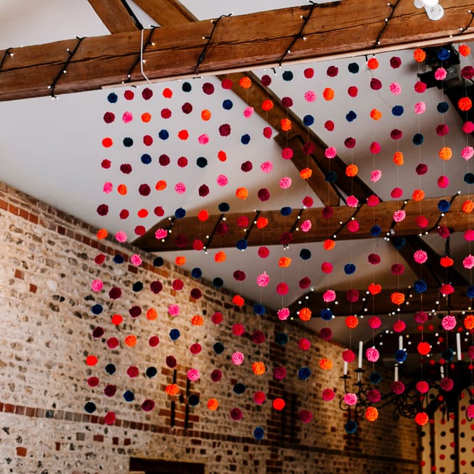 Hanging Pom Pom Wedding Decor | Colourful Alternative Winter Wedding at Upwaltham Barns, Sussex | Epic Love Story Photography