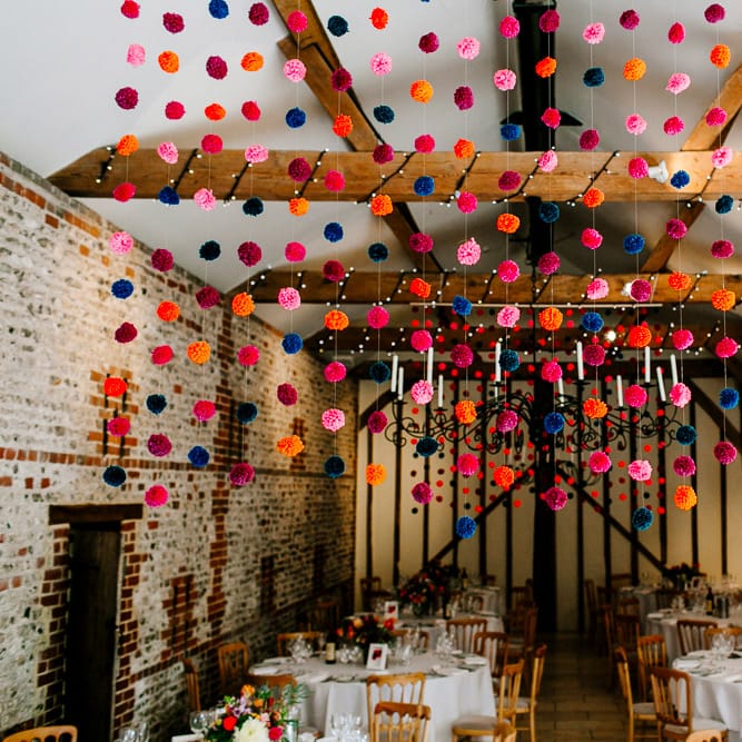 Hanging Pom Pom Wedding Decor | Colourful Alternative Winter Wedding at Upwaltham Barns, Sussex | Epic Love Story Photography