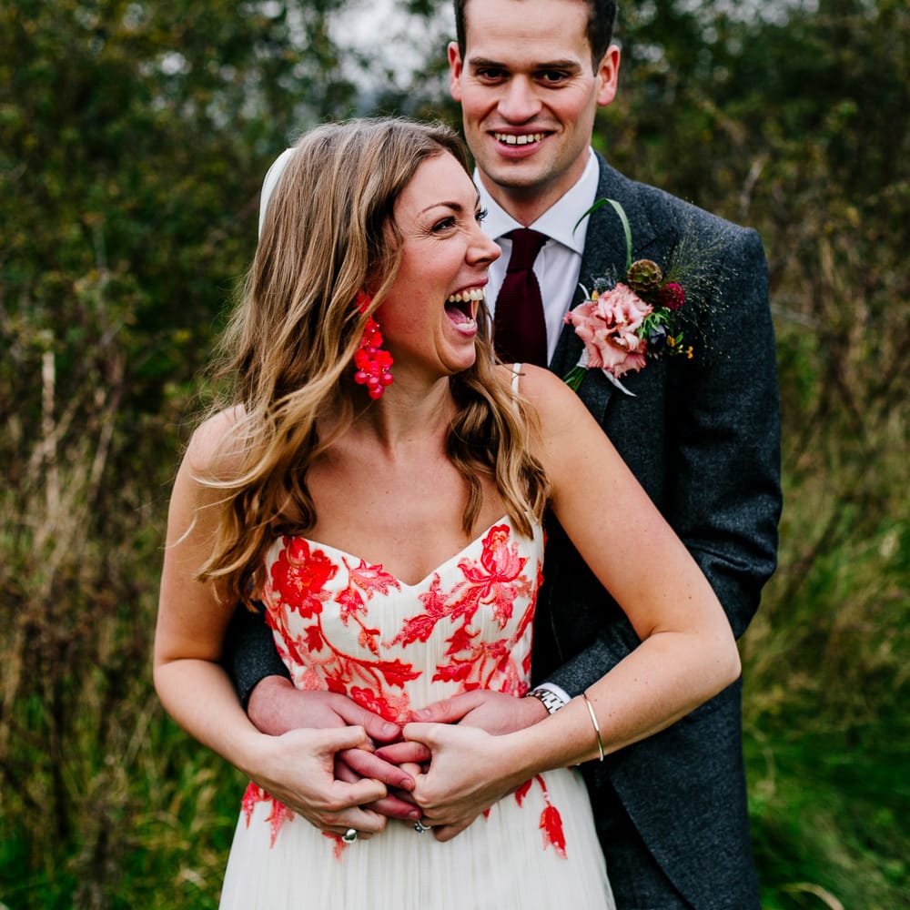 Bride in Red &amp; White Joanne Fleming Design Wedding Dress | Groom in Suit Supply Suit | Colourful Alternative Winter Wedding at Upwaltham Barns, Sussex | Epic Love Story Photography
