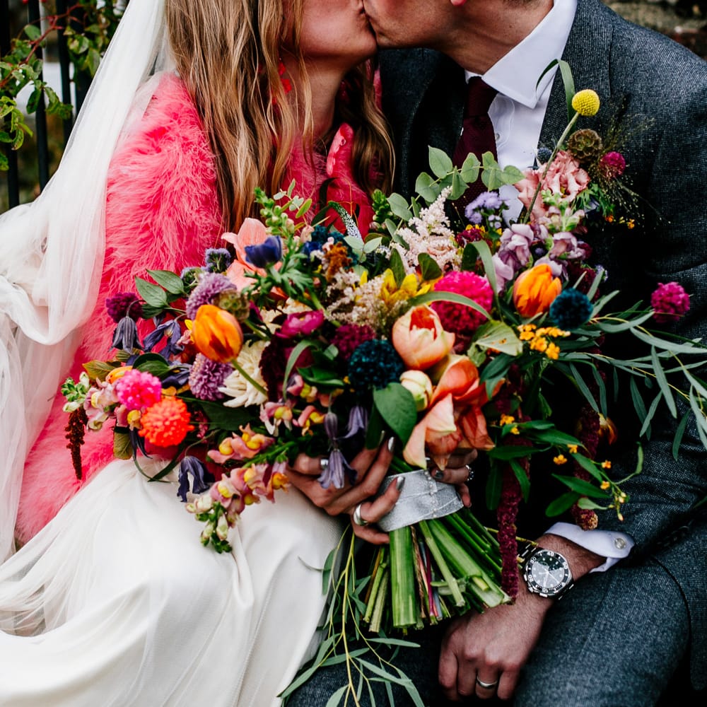Oversized Colourful Bouquet | Bride in Red &amp; White Joanne Fleming Design Wedding Dress | Groom in Suit Supply Suit | Colourful Alternative Winter Wedding at Upwaltham Barns, Sussex | Epic Love Story Photography