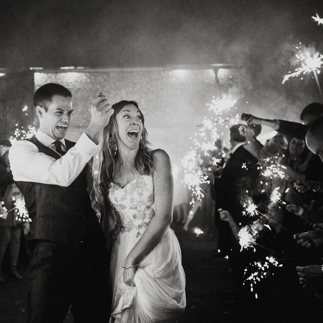 Sparkler Moment | Bride in Red &amp; White Joanne Fleming Design Wedding Dress | Groom in Suit Supply Suit | Colourful Alternative Winter Wedding at Upwaltham Barns, Sussex | Epic Love Story Photography