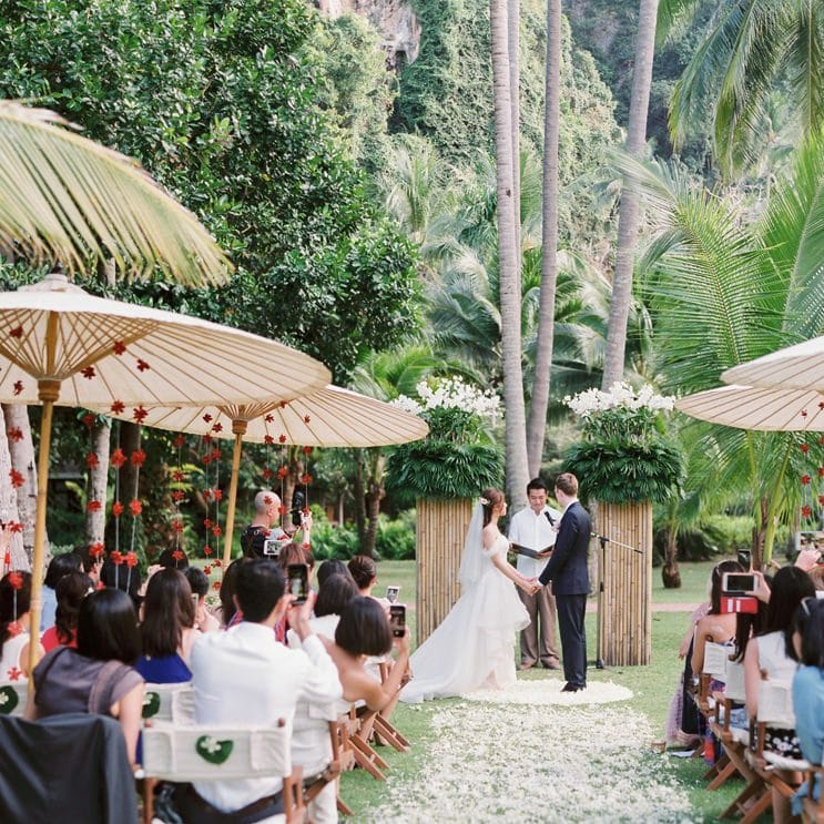 Bride and groom exchanging vows at Thailand tropical wedding