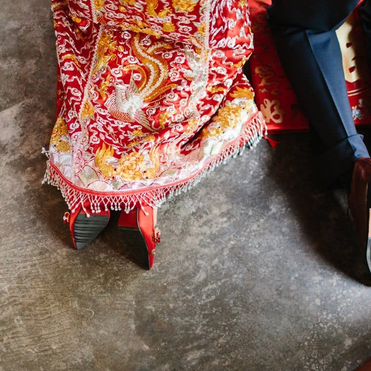 Bride and groom kneeling at Chinese Tea Ceremony