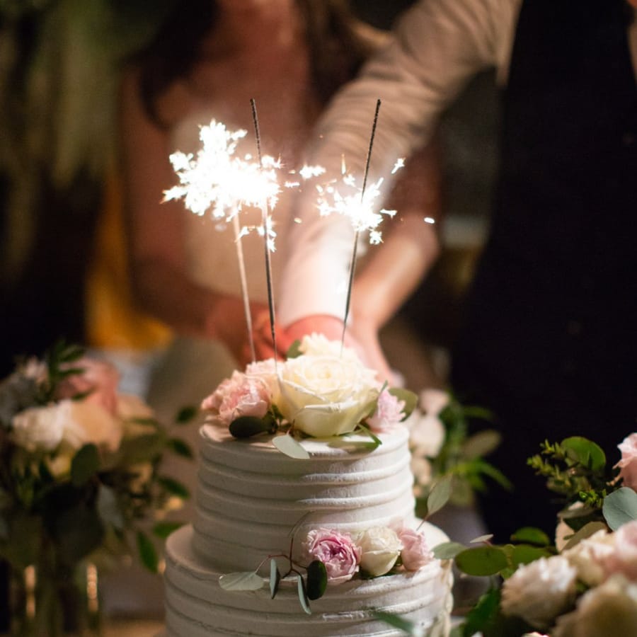 White wedding cake with sparkler topper