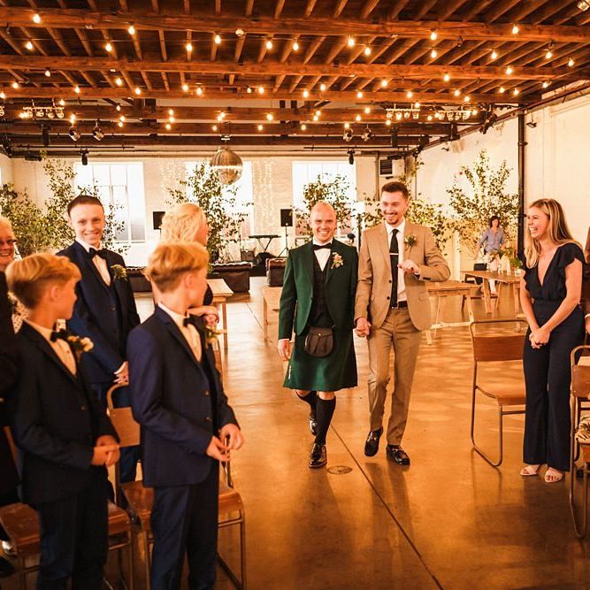 Grooms walk down the aisle together