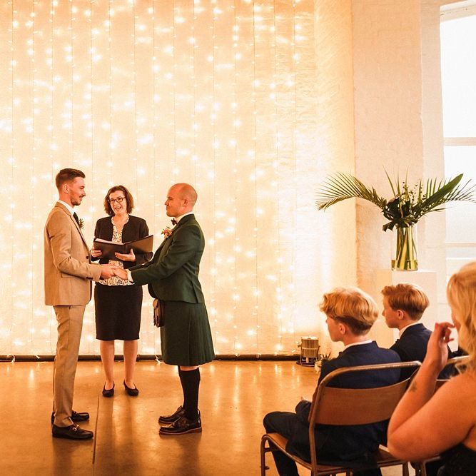Fairy light backdrop for same sex wedding at  Trinity Buoy Wharf