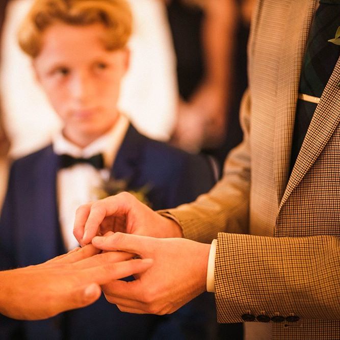 Grooms exchange rings at  Trinity Buoy Wharf wedding