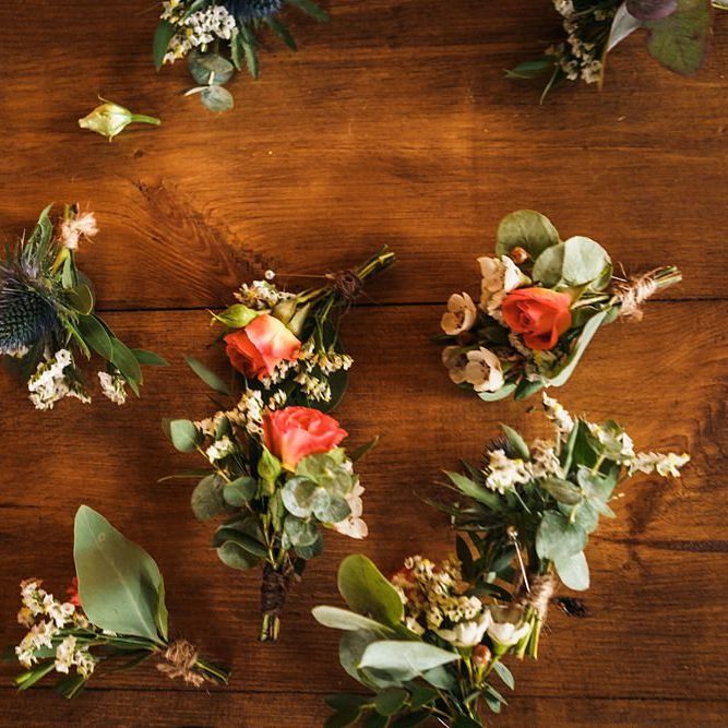 Orange buttonholes for grooms and wedding party