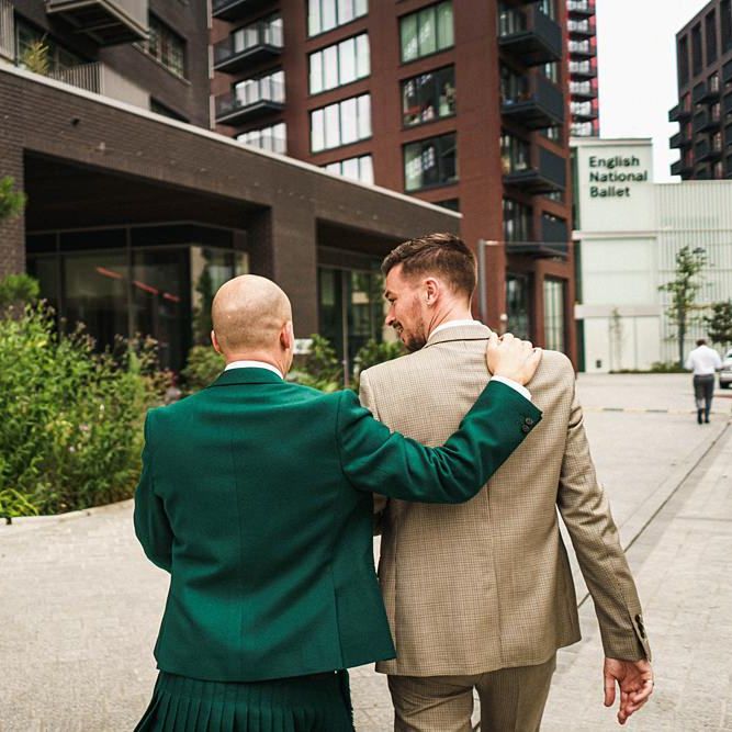 Groom in green wedding suit with his new husband