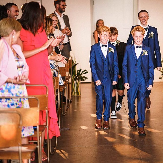 Page boys walk down the aisle at  Trinity Buoy Wharf