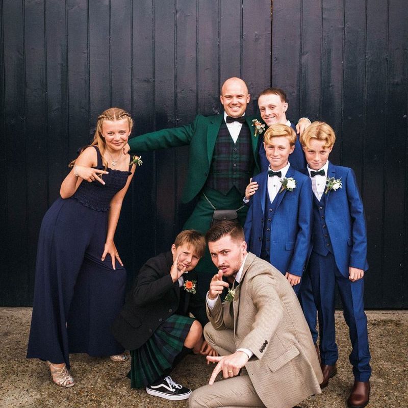 Grooms with their wedding party outside London venue