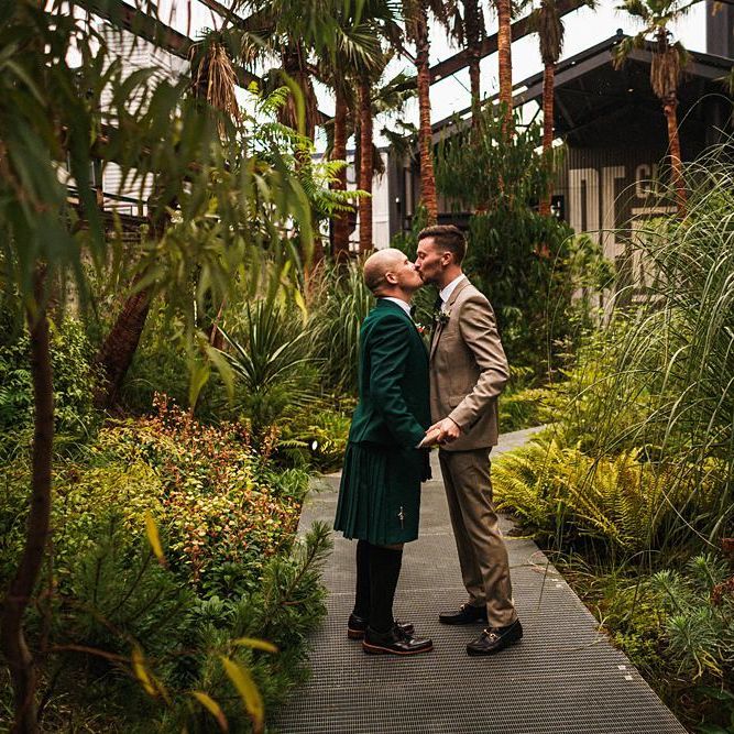 Grooms kiss at  Trinity Buoy Wharf wedding