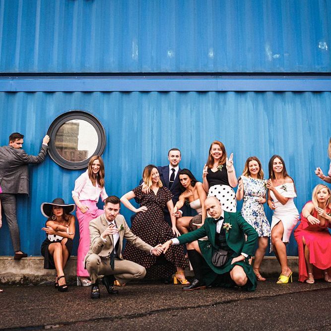 Grooms pose with guests at  Trinity Buoy Wharf wedding