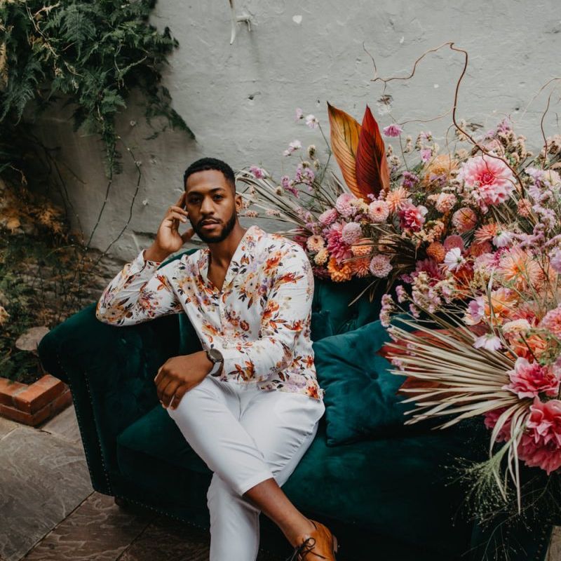 Groom in floral shirt and white trousers at Secret Garden Kent