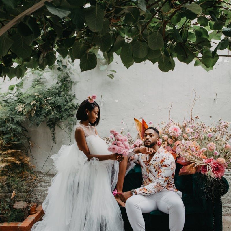 Bride in tulle wedding dress and groom floral shirt at tropical wedding inspiration