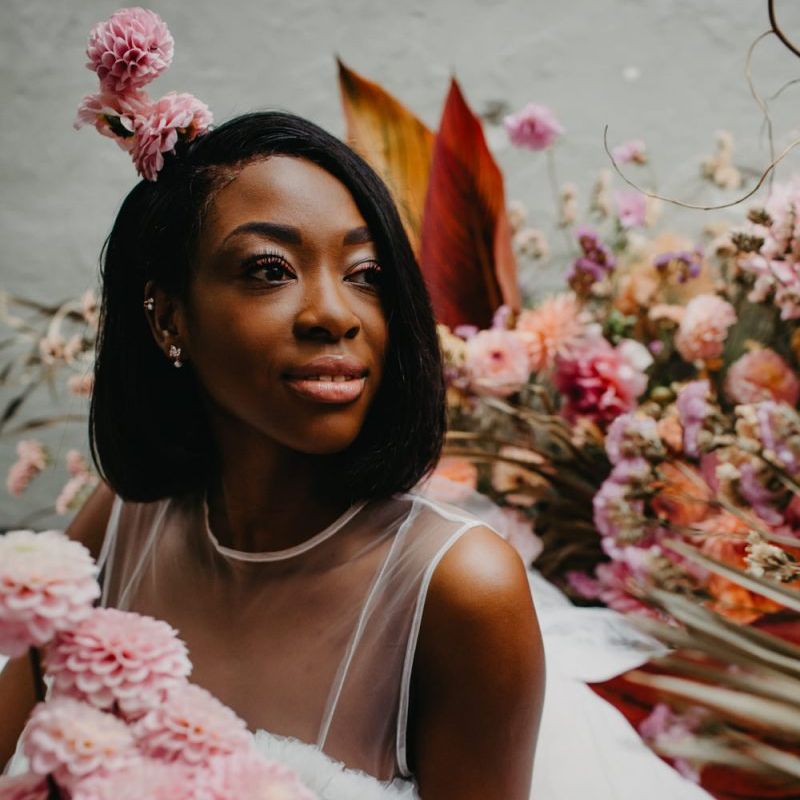 Beautiful bride with bob sat amongst the flowers